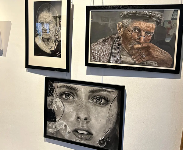 3 of zeynep's paintings in an exhibition centre in Toronto